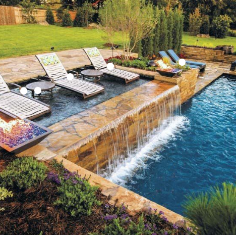 1. A serene backyard pool featuring lounge chairs and a cascading waterfall, perfect for relaxation and leisure.