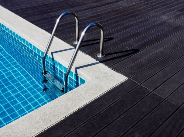 2. A serene pool scene showcasing a ladder and a vibrant blue tile floor, perfect for summer enjoyment.